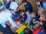 Chef Mary Kiernan demonstrates the rainbow of foods to children