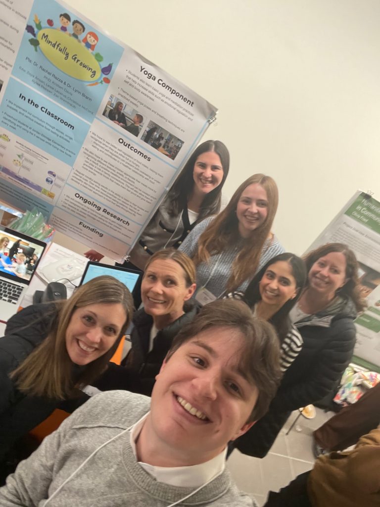 group photo of lab members at SOURCE poster event