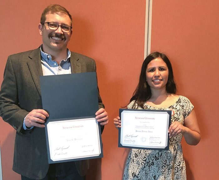 Student and Professor pose with award certificates