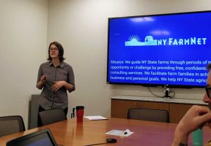 student presenting with TV monitor behind her