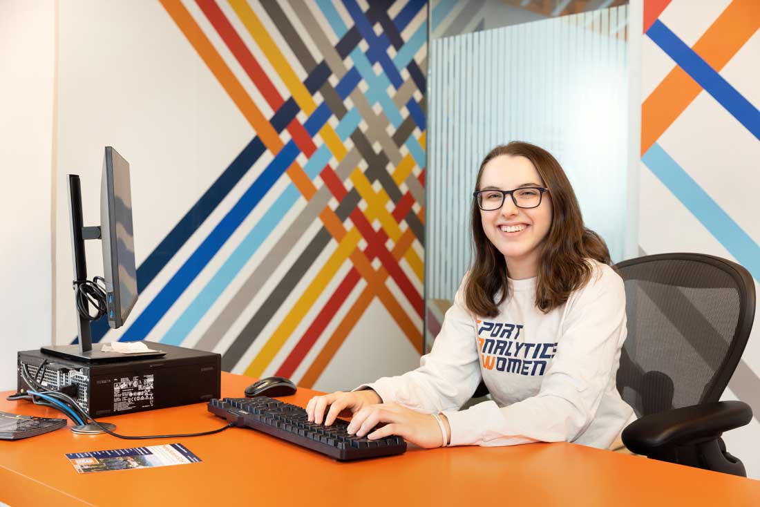 Alison sits at a computer