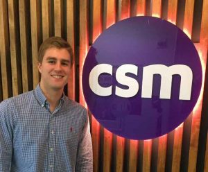 Andrew Derda poses with CSM logo