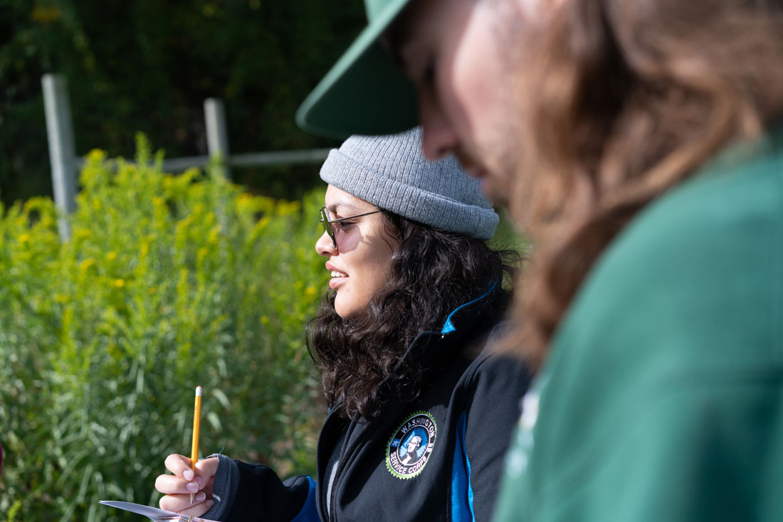 April stands in a garden with other students