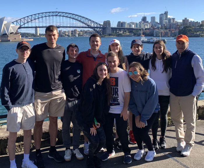 A group of students and professors are posed in Sidney Bay Area