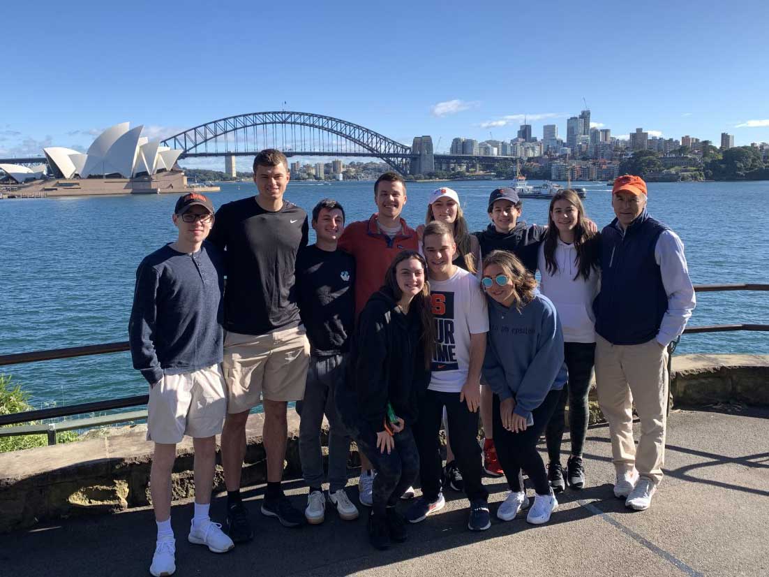 A group of students and professors are posed in Sidney Bay Area