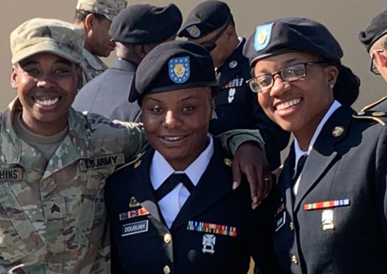U.S. Army veteran Benetta Dousuah G’25 (center) poses with two of her fellow service members.