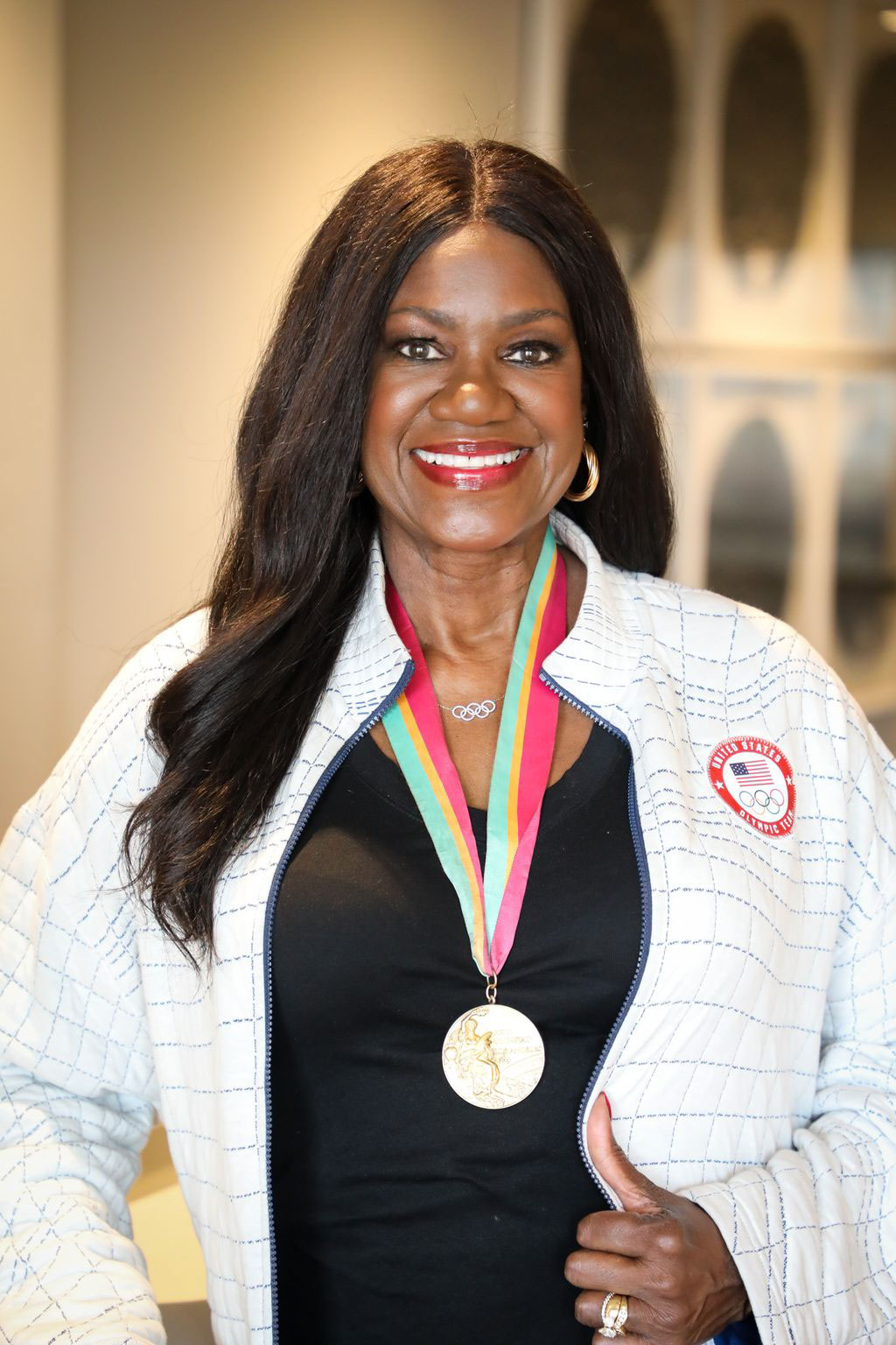 olympic gold medal winner in track wearing her gold medal and olympic necklace