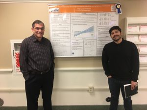 Brooks Gump and Ivan Castro stand next to a research poster