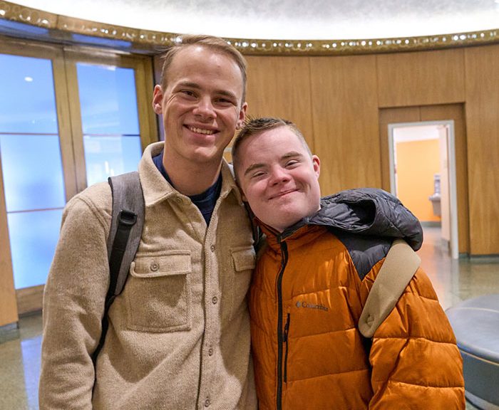 Luke and Mark Radel standing together in lobby of Schine Student Center