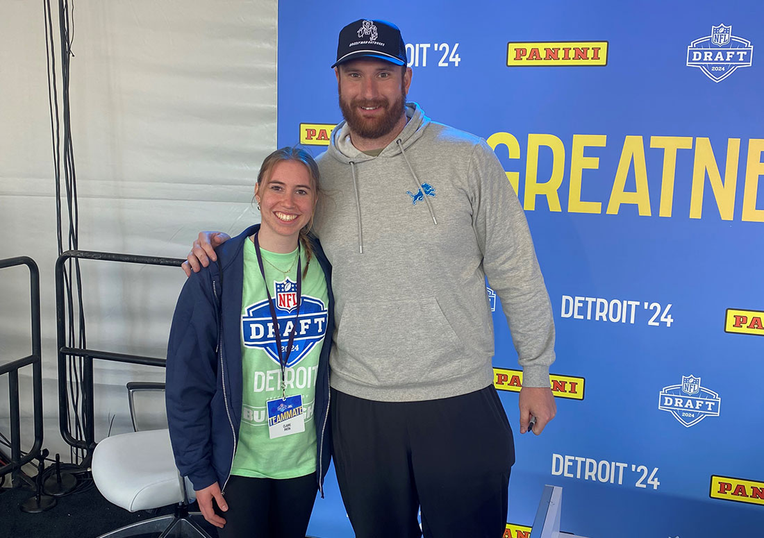 Female SPM student with Detroit Lions center standing together