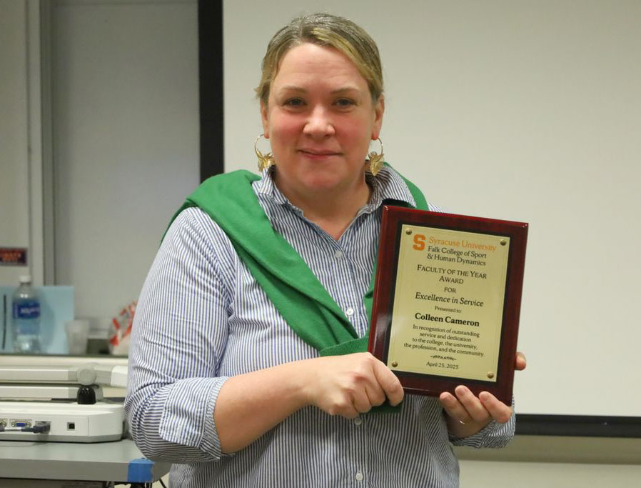 Colleen Cameron holding her awards plaque