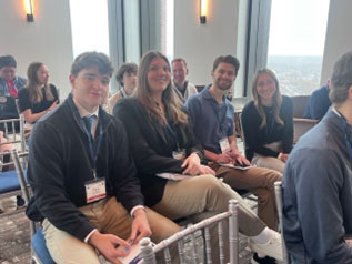 Students sitting in chairs attending the Connecticut Sports Analytics Symposium