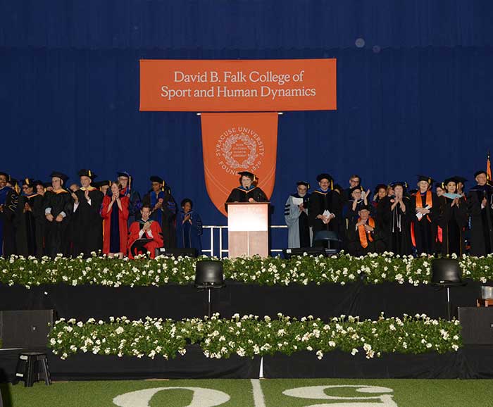 Faculty and Dean Murphy on stage during convocation