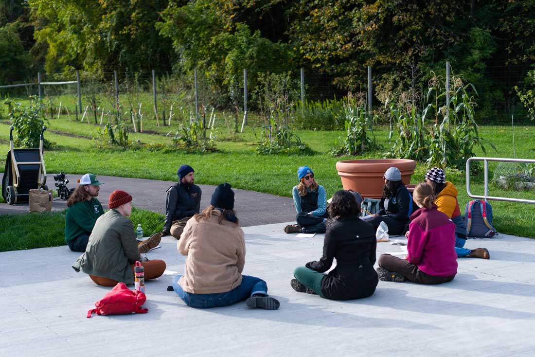 Students study together sitting on the ground