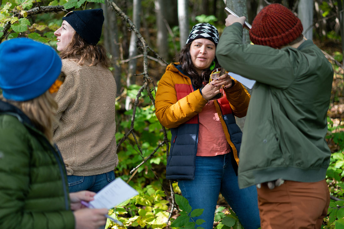 Students together outside near a forest