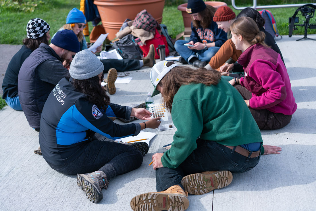 Students study together sitting on the ground