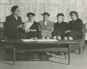 A 1953 photo of 5 women sitting on a couch.