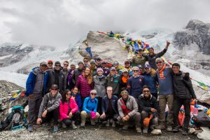 A photo of a large group of climbers posed on a mountain.