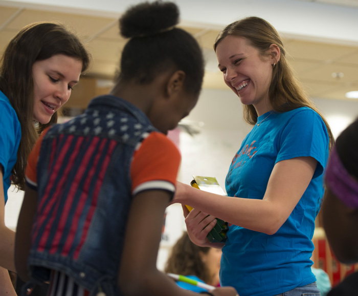 Nutrition major Elizabeth Gardner helps students at Dr. Weeks Elementary School learn about the culture and cuisine of Puerto Rico.