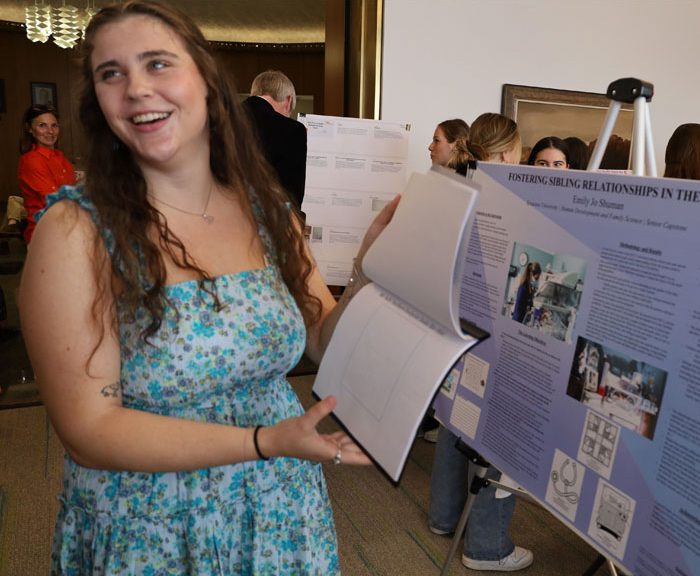 Emily stands by her research poster