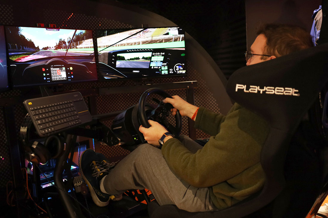 Young man driving racing simulator