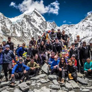 A large group of students sitting on the side of a mountain range