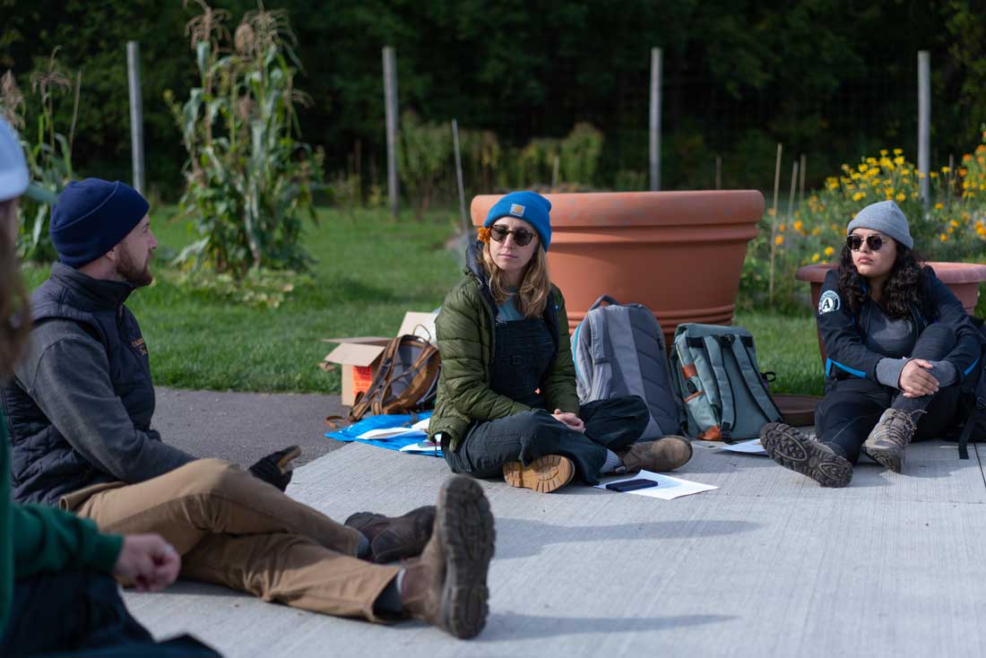 Students sit on a patio in a garden