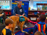 Man and a service dog with children