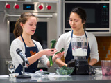 Students give a cooking demonstration