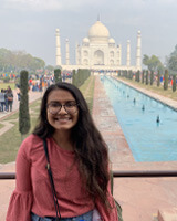 Public health alumna Bijal Patel stands in front of the Taj Mahal in India.