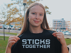 Sarah Thompson wearing a shirt that reads "Sticks Together."