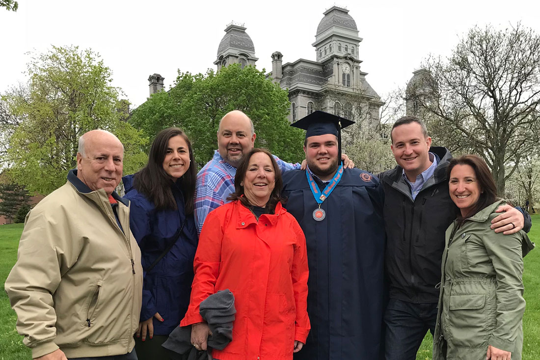 hirsh fmaily of 7 standing in front of hall of languages on syracuse university campus