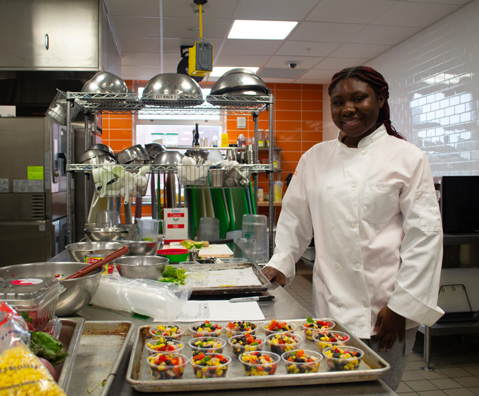 Georgia Barton cooking in the Klenk Kitchens.