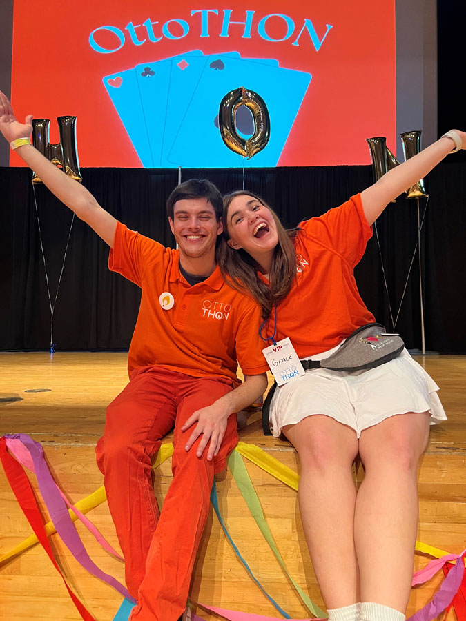 Two students are posed on a stage