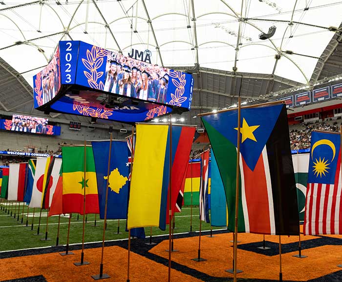 diverse country flags are showing during a graduation ceremony
