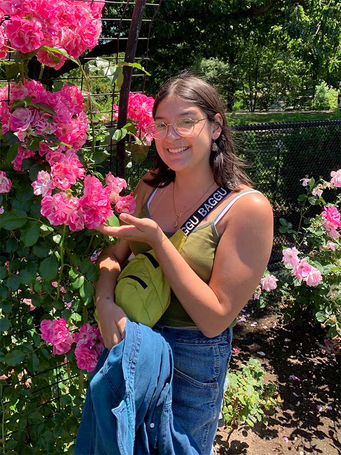 Avalon poses with roses in a garden