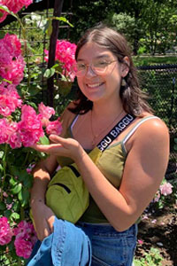 Avalon poses with roses in a garden