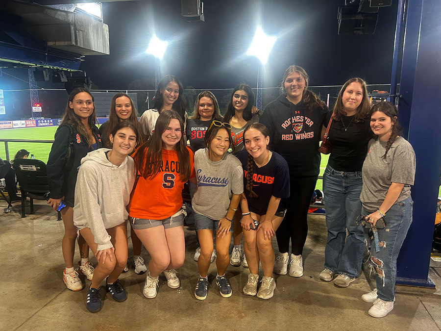 female members of Sports Analytics Womens student organization standing in two rows. 8 in back and 4 in front.