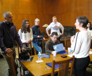 People surrounding a table preparing for a film shoot.