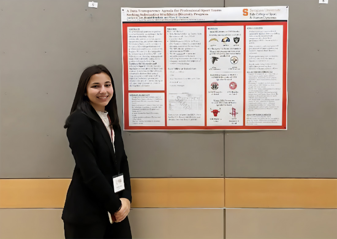 Jordyn stand next to a research poster