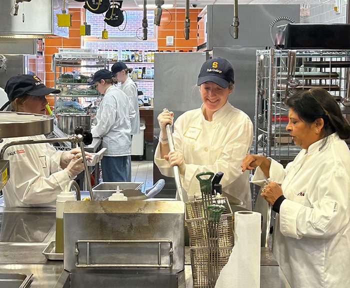 Students working in Klenk kitchen with Chef Gadia