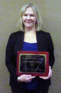Sandra D Lane holds an award