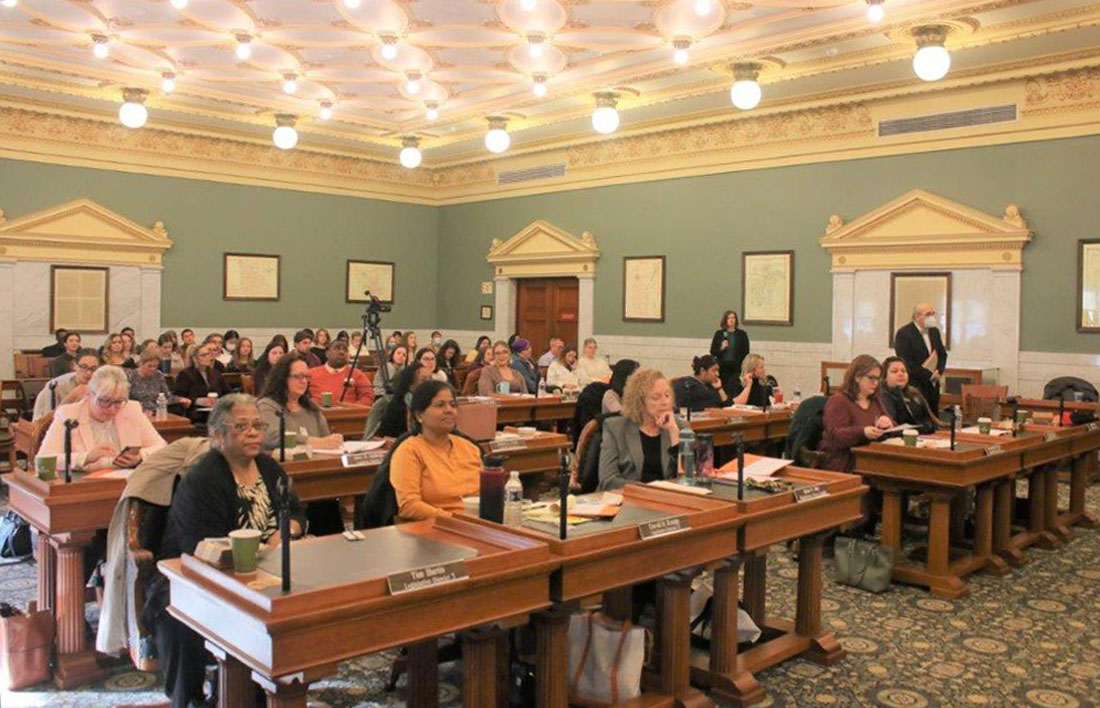 A group of people are sitting in a courtroom