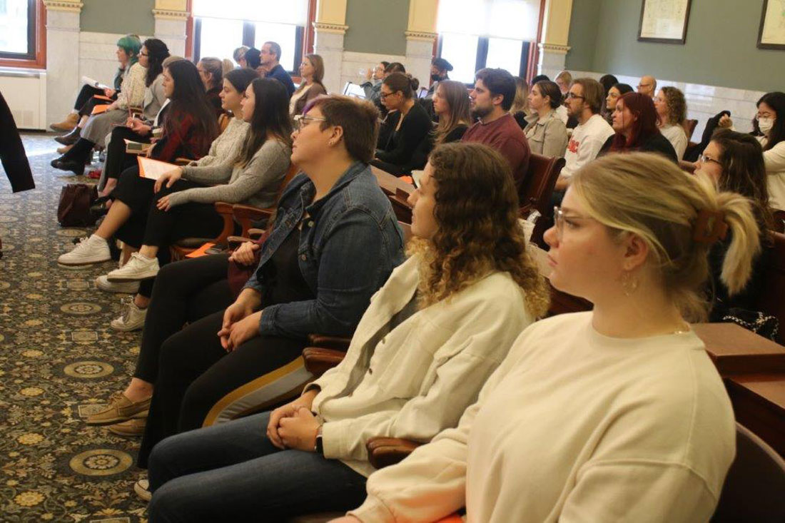 A group of people sitting in a courtroom