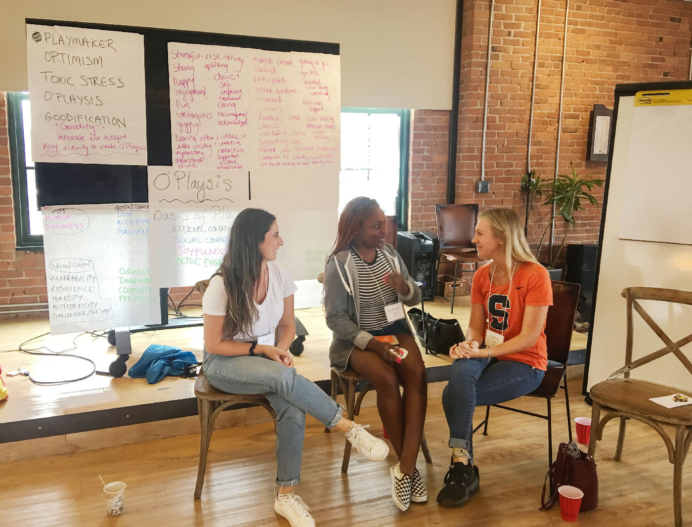 Three students sit and discuss