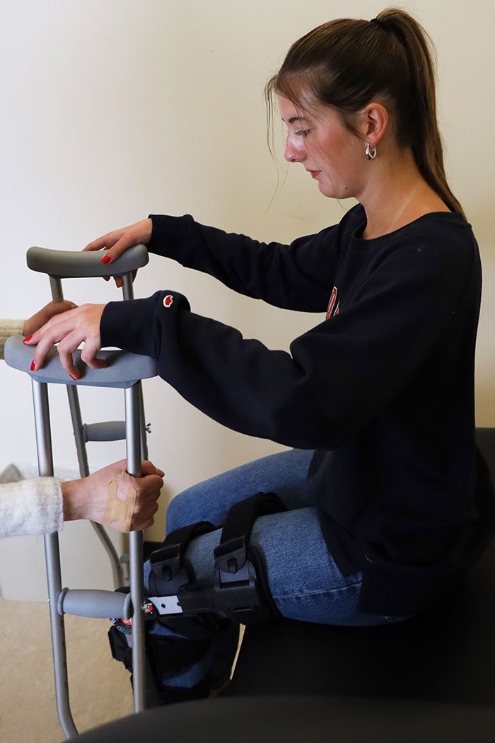 student learns to use crutches while wearing leg brace as part of research study