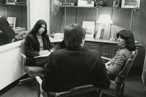 A student counsels a couple in a counseling office