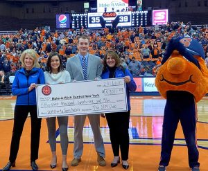 A check is presented on a basketball court during a game