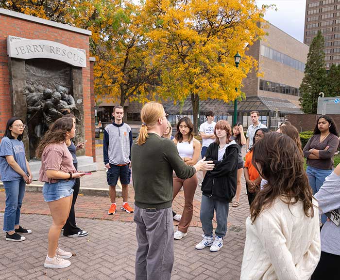 A group of students listen to a tour guide