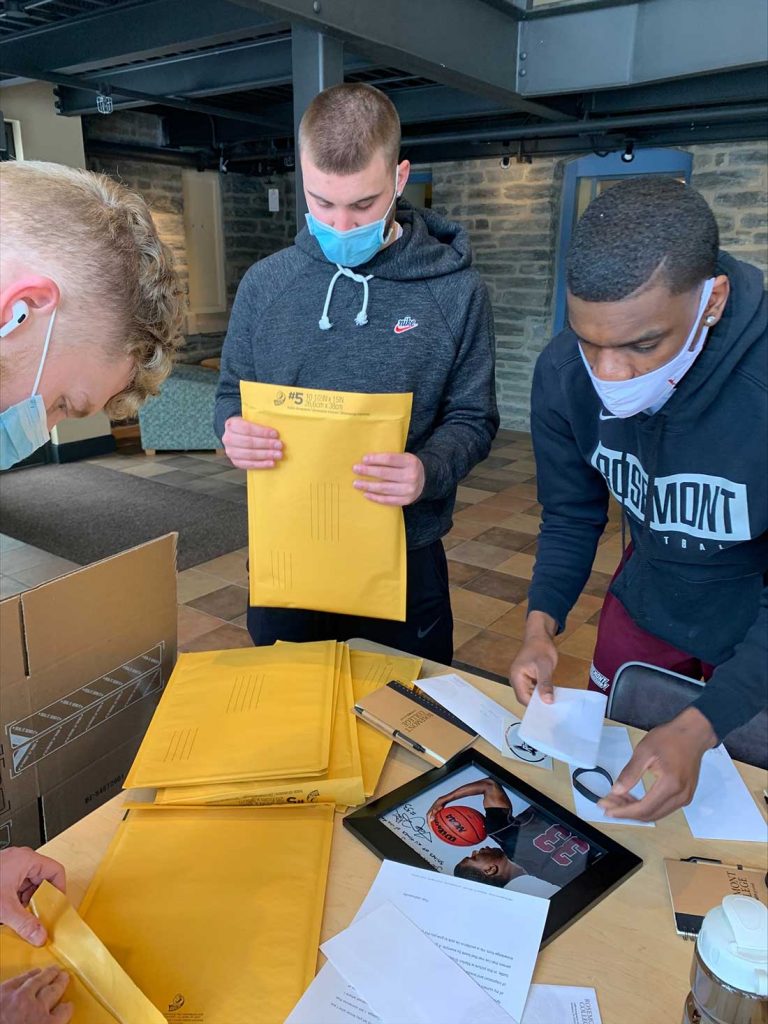 three individuals are sorting packets